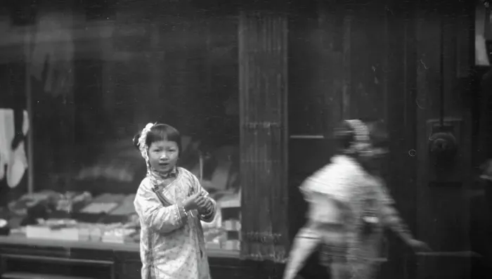 Framed Print : Young girl walking down the street, looking into the camera, Chinatown, San Francisco, c1896-1906. Creator: Arnold Genthe Framed Print : Young girl walking down the street, looking into the camera, Chinatown, San Francisco, c1896-1906. Creator: Arnold Genthe