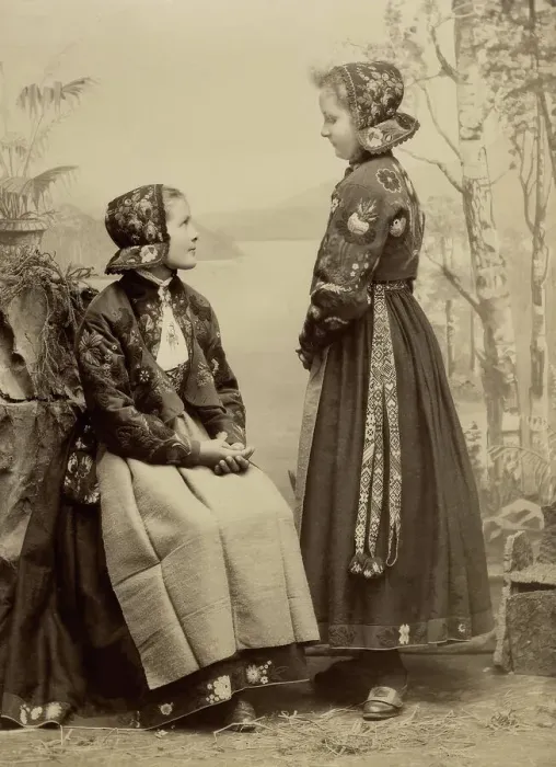Framed Print : Two young girls pose in costumes from Dala-Floda with floral jackets and hats, 1890-1900. Creator: Helene Edlund Framed Print : Two young girls pose in costumes from Dala-Floda with floral jackets and hats, 1890-1900. Creator: Helene Edlund