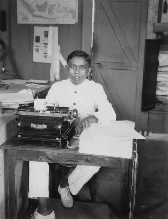 Framed Print : A young man sitting at a typewriter, Indonesia, 20th century Framed Print : A young man sitting at a typewriter, Indonesia, 20th century