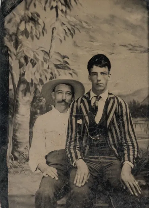 Framed Print : Young Man in a Striped Jacket, Sitting on the Lap of Another Man in Front of Painted Framed Print : Young Man in a Striped Jacket, Sitting on the Lap of Another Man in Front of Painted
