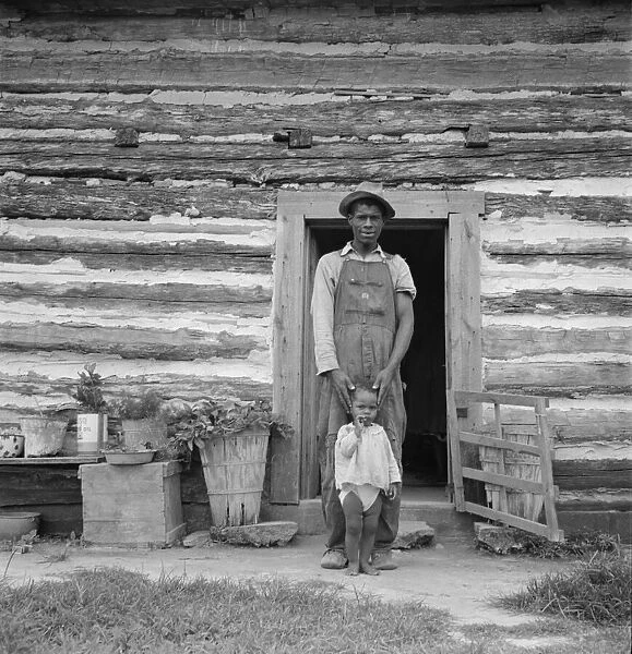 Young sharecropper and his first child, Hillside Farm, Person County, North Carolina, 1939. Creator: Dorothea Lange