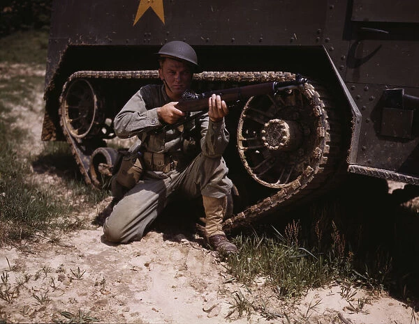 A young soldier of the armored forces holds and sights his Garand rifle like... Fort Knox, Ky, 1942 Creator: Alfred T Palmer