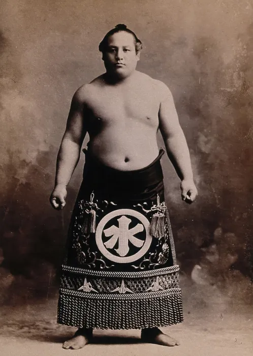 Framed Print : A young sumo wrestler posing in a photographic studio, wearing a richly decorated apron... c1900. Creator: Unknown Framed Print : A young sumo wrestler posing in a photographic studio, wearing a richly decorated apron... c1900. Creator: Unknown