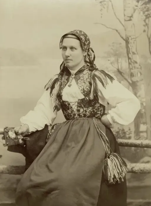 Framed Print : A young woman poses in a folk costume, 1890-1920. Creator: Helene Edlund