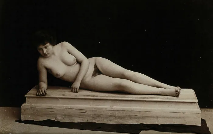 Framed Print : A young woman posing naked in a photographic studio, lying on a wooden plinth, approx 1900. Creator: Unknown Framed Print : A young woman posing naked in a photographic studio, lying on a wooden plinth, approx 1900. Creator: Unknown