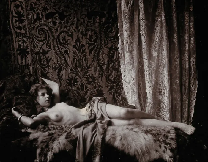 Framed Print : A young woman, posing semi-naked in a photographic studio, lying full-length on a fur... c1900. Creator: Unknown Framed Print : A young woman, posing semi-naked in a photographic studio, lying full-length on a fur... c1900. Creator: Unknown