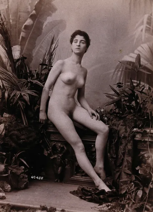 Framed Print : A young woman seated on a low balustrade posing naked, c1900. Creator: Unknown Framed Print : A young woman seated on a low balustrade posing naked, c1900. Creator: Unknown