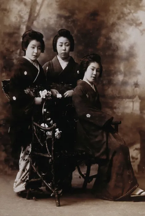 Framed Print : Three young women posing in a photographic studio, one seated on a bench... early 20th century. Creator: Unknown Framed Print : Three young women posing in a photographic studio, one seated on a bench... early 20th century. Creator: Unknown
