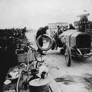 1908 Mercedes, Lautenschlager, changing wheel, winner French Grand Prix. Creator: Unknown