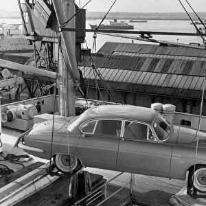 1962 Jaguar MkX being loaded on to Saxonia ship at Southampton docks for export. Creator: Unknown