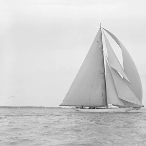 The 23-metre cutter Astra sailing with spinnaker. Creator: Kirk & Sons of Cowes