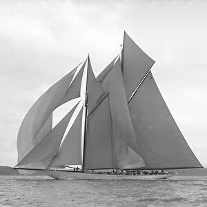 The 250 ton schooner Germania sails downwind under spinnaker, 1911