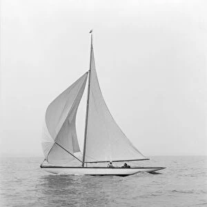 The 6 Metre class Marmi sailing under spinnaker, 1914. Creator: Kirk & Sons of Cowes