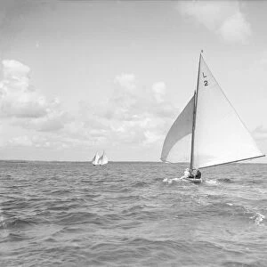 The 6 Metre Cynthia running downwind under spinnaker, 1912. Creator: Kirk & Sons of Cowes
