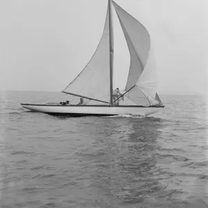 The 6 Metre Vanda sailing with spinnaker, 1914. Creator: Kirk & Sons of Cowes