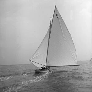The 7 Metre Marsinah (K1) sailing with spinnaker, 1912. Creator: Kirk & Sons of Cowes