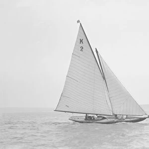 The 7 Metre yacht Ithnan (K2) sailing close-hauled, 1911. Creator: Kirk & Sons of Cowes