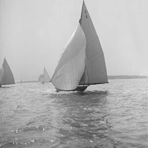 The 7 Metre yacht Pinaster (K8) sailing with spinnaker, 1914. Creator: Kirk & Sons of Cowes