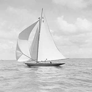The 7 Metre yacht Pinaster (K8) sailing with spinnaker, 1912. Creator: Kirk & Sons of Cowes