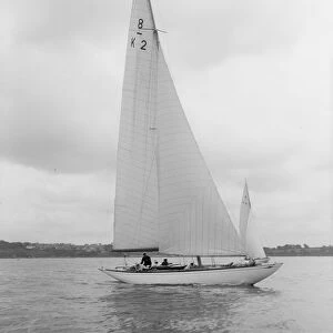 The 8 Metre Carron (K2) sailing upwind, 1934. Creator: Kirk & Sons of Cowes