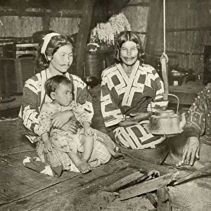 Ainu Man and Women at Home, 1910. Creator: Herbert Ponting