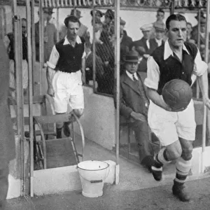 Arsenal FC captain Eddie Hapgood runs onto the pitch at Highbury, London, 1930s. Artist: Barratts Photo Press Ltd
