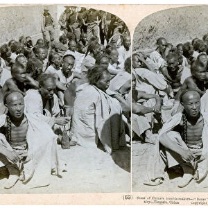 Boxer prisoners captured and brought in by the US 6th Cavalry, Tientsin, China, 1901. Artist: Underwood & Underwood