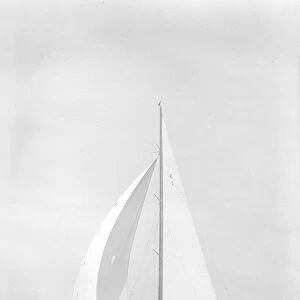 Britannia sails downwind under spinnaker, 1935. Creator: Kirk & Sons of Cowes