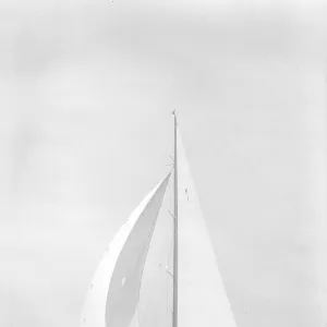 Britannia sails downwind under spinnaker, 1935. Creator: Kirk & Sons of Cowes