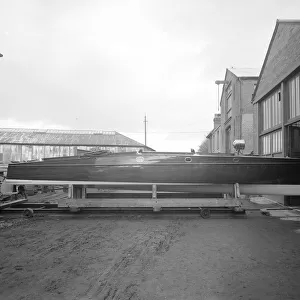 Cabin cruiser D. G. S. I. on stand at boatyard, 1913. Creator: Kirk & Sons of Cowes