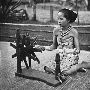 A Dayak girl at her spinning wheel, 1902