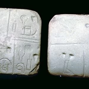 Early Sumerian stone tables, inscribed with very early archaic pictographic symbols