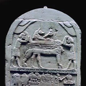 Egyptian stele showing Anubis preparing a mummy