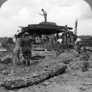 Engineers clearing a destroyed tank from a road, World War I, 1917-1918. Artist: Realistic Travels Publishers