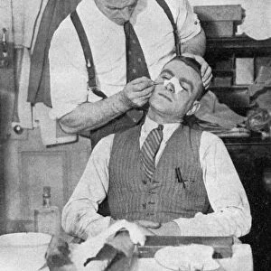 England captain Eddie Hapgood receives treatment for a broken nose after a match with Italy, 1934. Artist: Topical Press Agency
