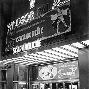 Facade of old cinema Windsor in Barcelona with neon signs advertising the film Scaromouche