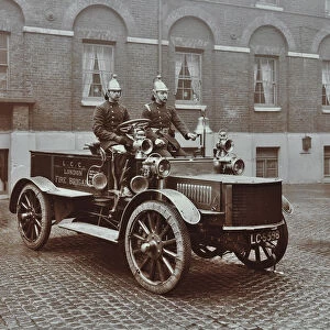 Firemen in brass helmets aboard a motor hose tender, London Fire Brigade Headquarters, London, 1909
