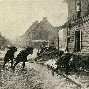 French troops crossing a village street under German fire, First World War, 1914-1915, (c1920)