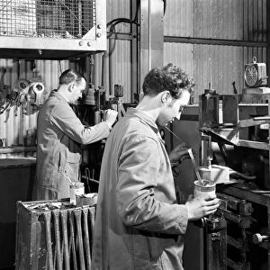 Heading at the Edgar Allen Steel Foundry, Sheffield, South Yorkshire, 1962. Artist