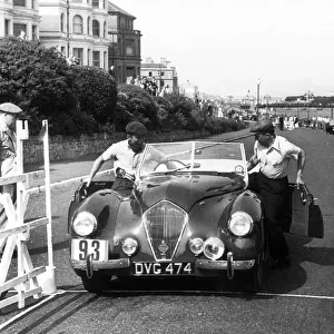 Healey Westland 2. 4, Eastbourne Rally 1952, S. P. A. Freeman getting into car. Creator: Unknown