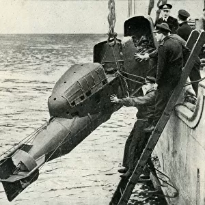 Hoisting a Chariot manned torpedo on board a ship, World War II, 1945. Creator: Unknown