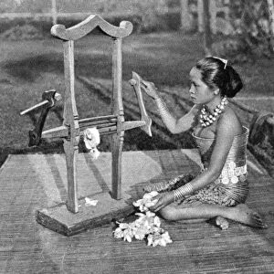 Iban woman making thread with a mangle, Borneo, 1922. Artist: Dr Charles Hose