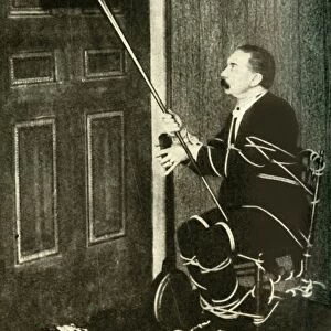 John Nevil Maskelyne performs a spirit cabinet illusion, c1910. Creator: Unknown