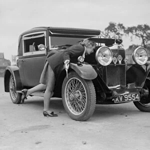 Kitty Brunell looking under the bonnet of a Talbot 14 / 45 sportsmans coupe, c1928