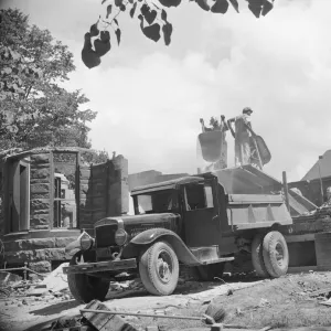 Loading debris from wrecked buildings along Independence Avenue, Washington, D. C, 1942. Creator: Gordon Parks