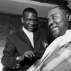 Louis Armstrong having haircut in Hammersmith, London, 1962. Creator: Brian Foskett