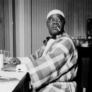 Louis Armstrong relaxing backstage, Finsbury Park Astoria, London, 1962. Creator: Brian Foskett