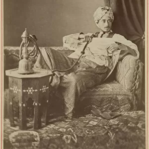 Marquis Claes Lagergren (1853-1930) in eastern costume smoking a hookah. Creator: Guillaume Berggren