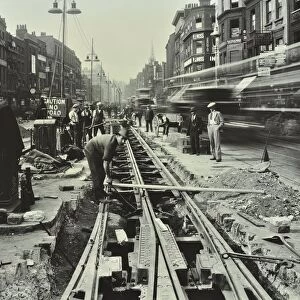 Men laying tramlines in the middle of the road, Whitechapel High Street, London, 1929
