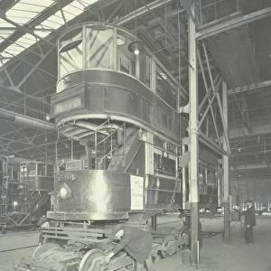Men using a car lifting hoist at Charlton Central Repair Depot, London, 1932